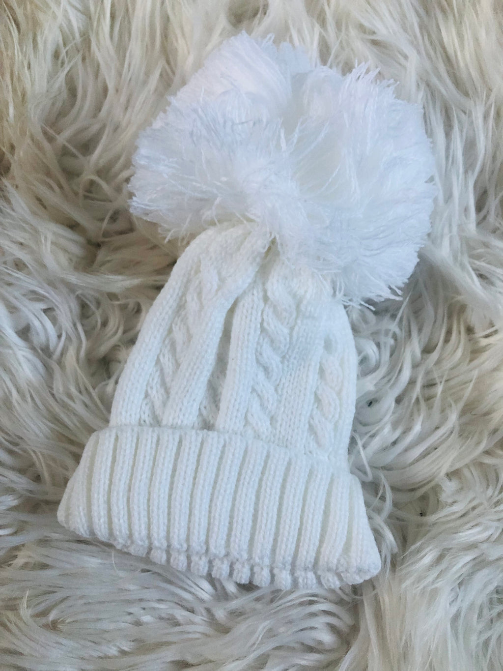 One size newborn to 12 m Pom Pom cable knitted hats